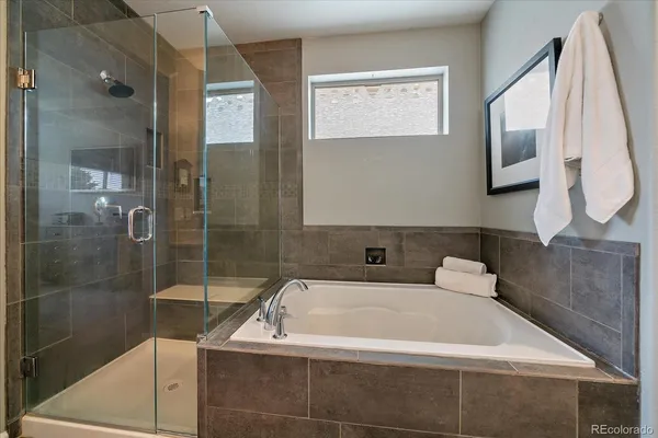 a bathroom with a bathtub and a shower