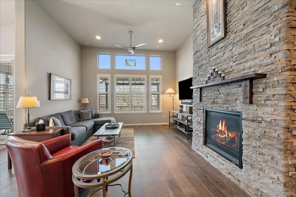 a living room with furniture a fireplace a flat screen tv and a fireplace