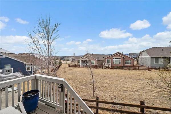 a view of a house with wooden chairs and a bench