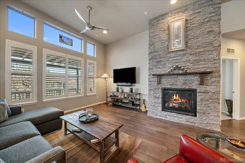 a living room with furniture a fireplace a flat screen tv and a fireplace