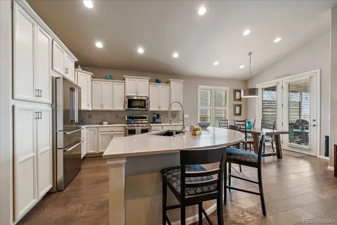 a dining room with furniture and wooden floor
