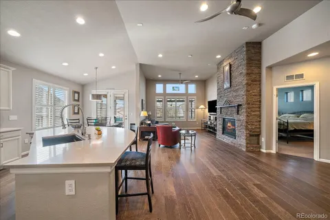 a kitchen with a sink a stove a refrigerator and white cabinets