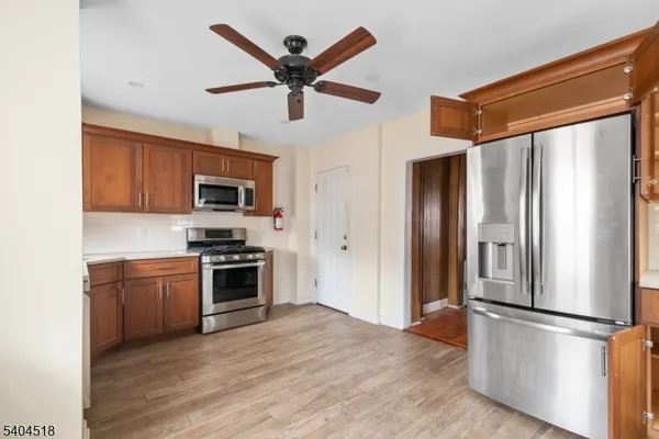 a kitchen with stainless steel appliances granite countertop a refrigerator a stove top oven a sink and dishwasher