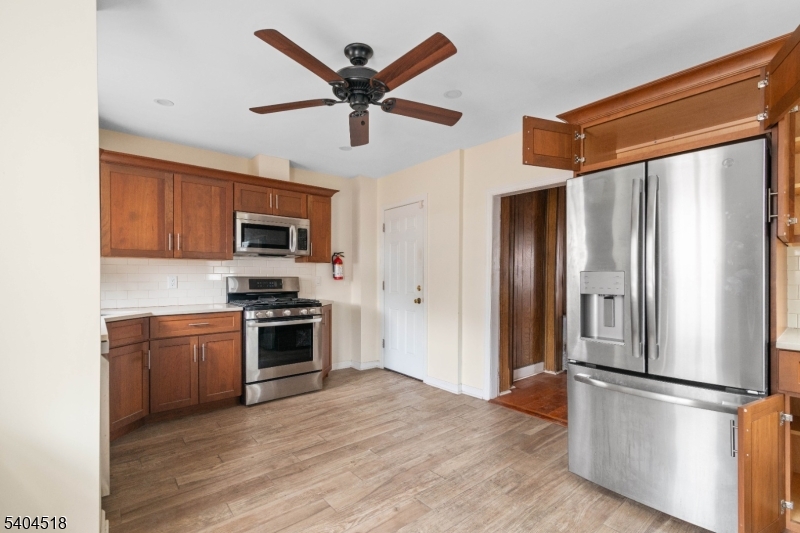 354 Hayward Street Orange, NJ 07050 - Photo 3 of 18 a kitchen with stainless steel appliances granite countertop a refrigerator a stove top oven a sink and dishwasher