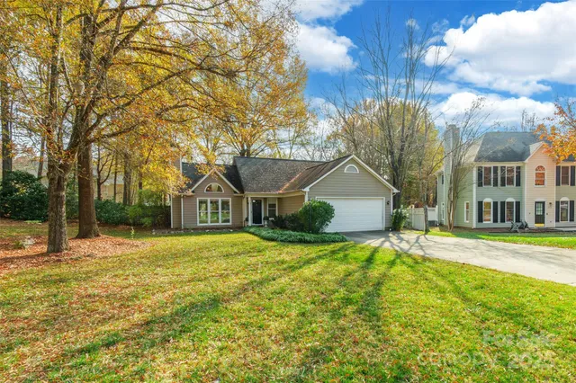a front view of house with yard and trees around
