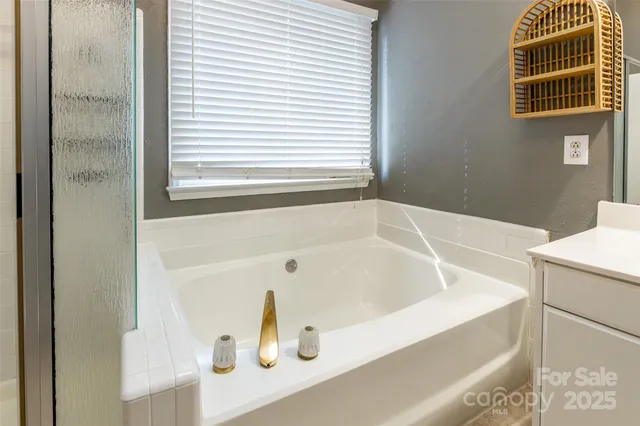 a bathroom with a tub and a window