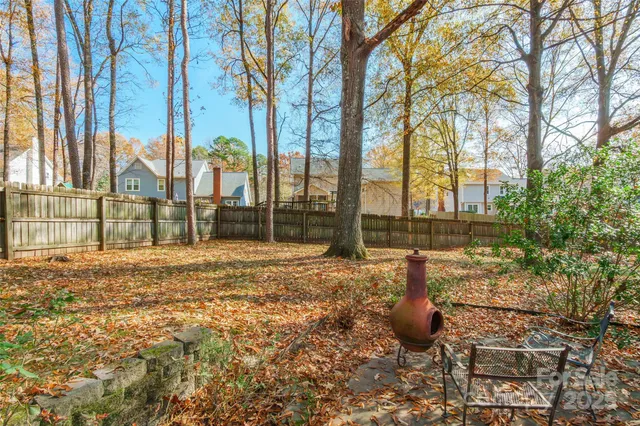 a view of a backyard with large trees