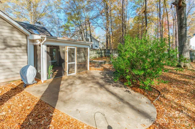 a view of a backyard with table and chairs and potted plants