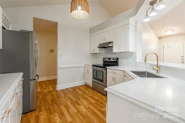 a kitchen with a sink appliances and cabinets