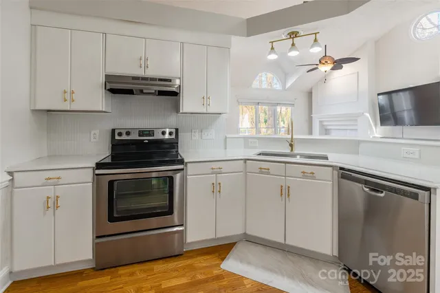 a kitchen with cabinets appliances and a sink