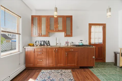 a kitchen with stainless steel appliances granite countertop a refrigerator dining table and chairs