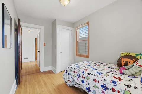 a bedroom with a large bed and a chandelier
