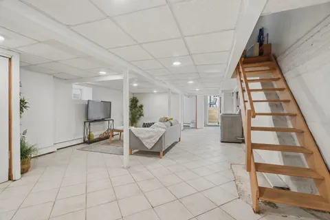 a living room with furniture and a potted plant