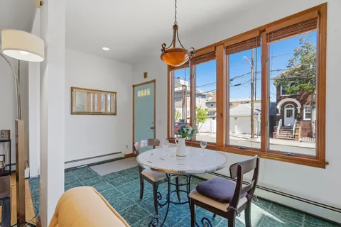a view of a dining room with furniture wooden floor and a window