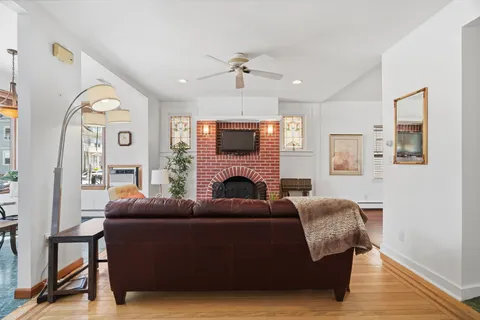 a living room with furniture a fireplace and a large mirror