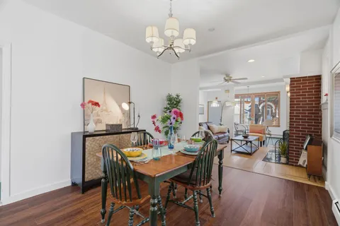 a view of a dining room with furniture wooden floor and chandelier