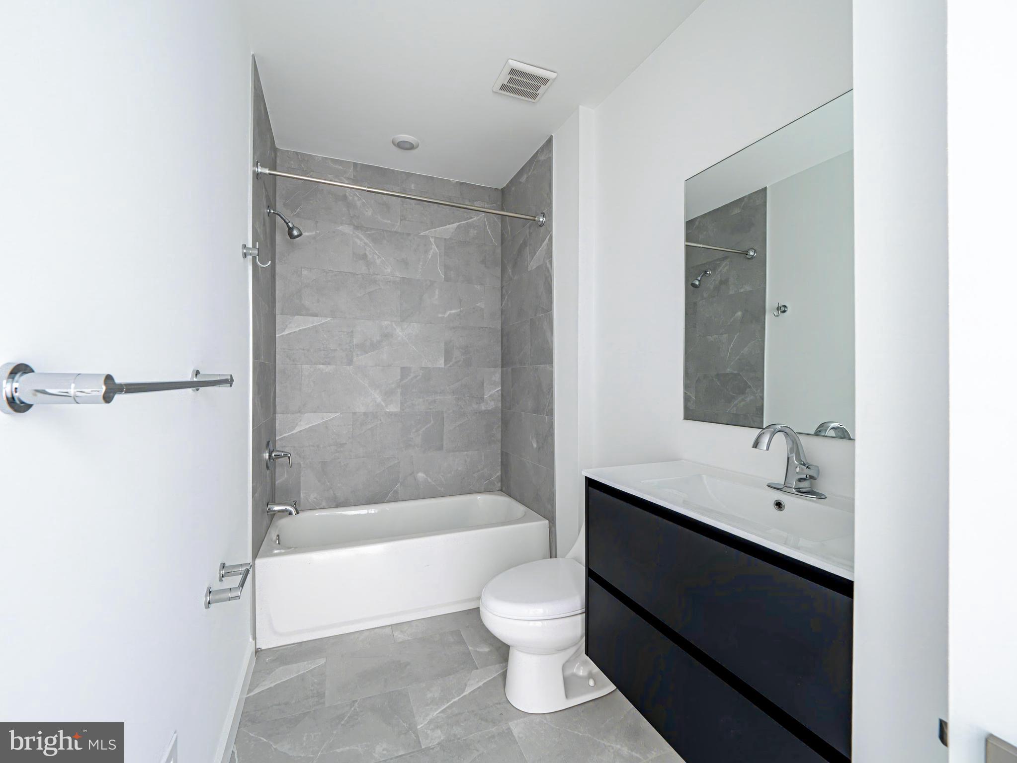 2403-2407 West Thompson Street, Unit 3 Philadelphia, PA 19121 - Photo 6 of 13 a bathroom with a double vanity sink toilet and shower