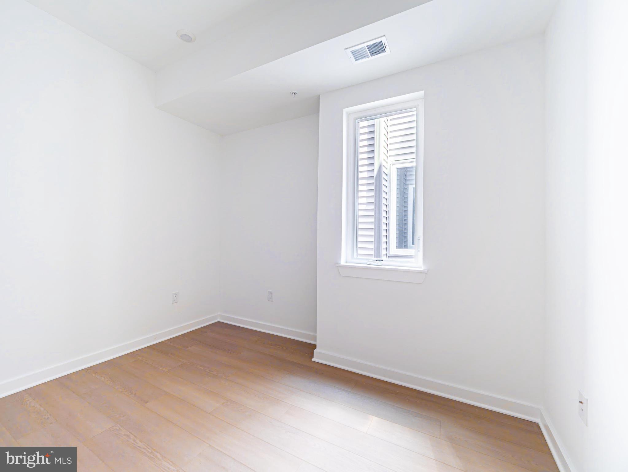 2403-2407 West Thompson Street, Unit 3 Philadelphia, PA 19121 - Photo 8 of 13 an empty room with a window