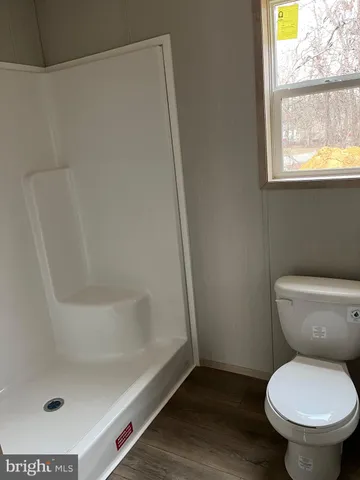 a bathroom with a toilet and a shower
