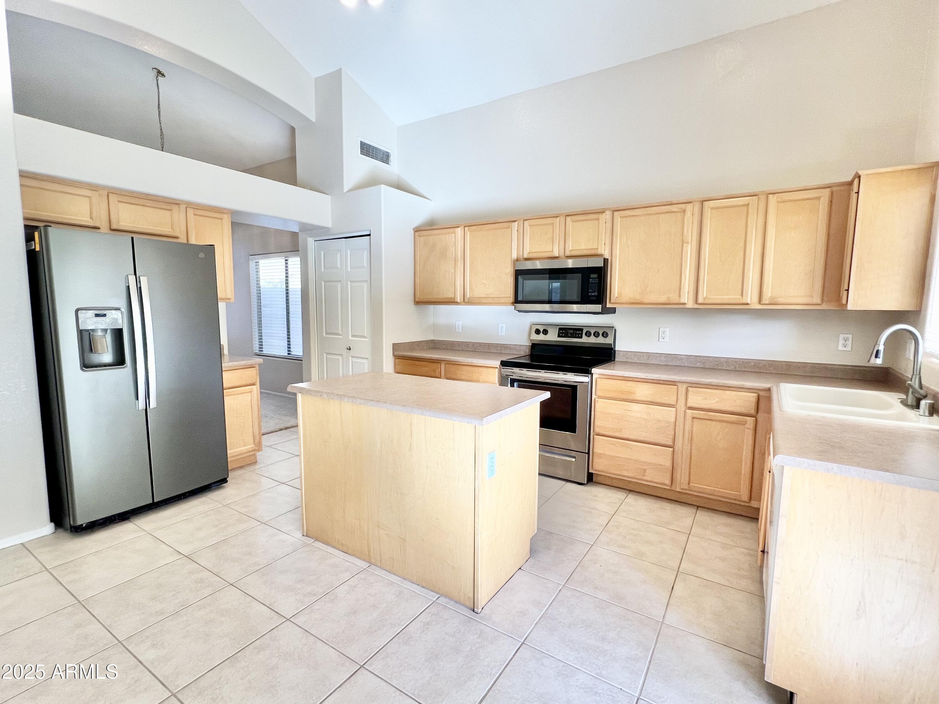 7309 West Mohawk Lane Glendale, AZ 85308 - Photo 12 of 24 a kitchen with stainless steel appliances a refrigerator sink and microwave