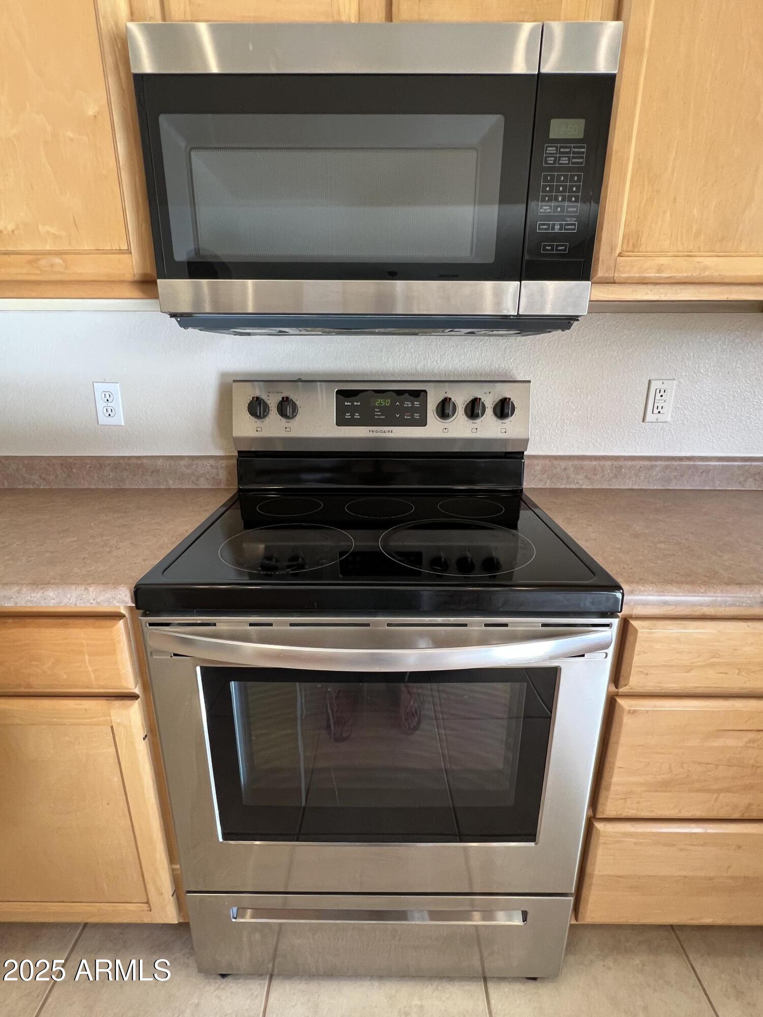 7309 West Mohawk Lane Glendale, AZ 85308 - Photo 13 of 24 a stove top oven sitting inside of a kitchen