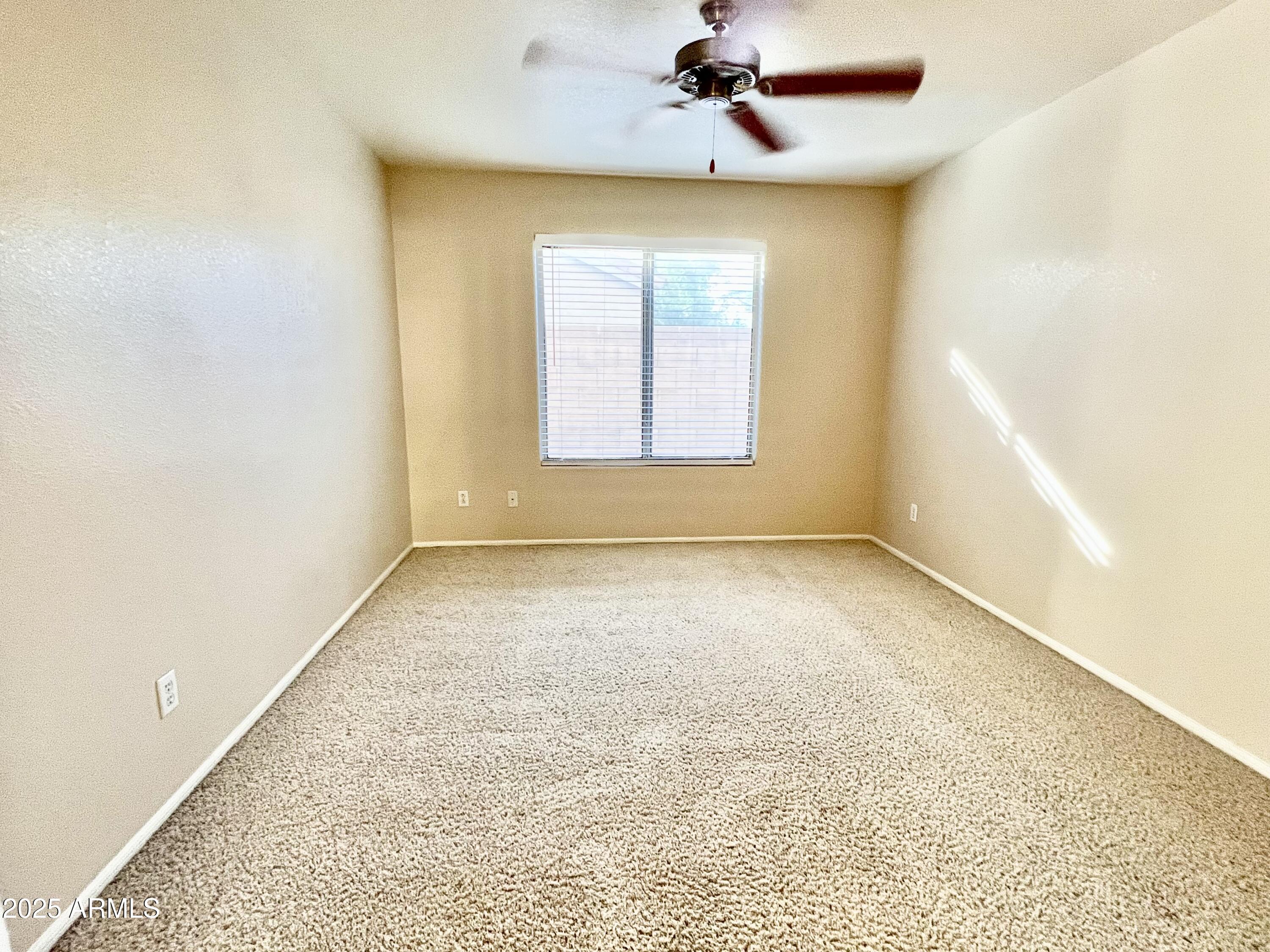 7309 West Mohawk Lane Glendale, AZ 85308 - Photo 15 of 24 an empty room with a window and a ceiling fan