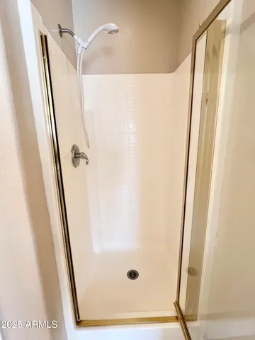 a bathroom with a glass shower door and a sink