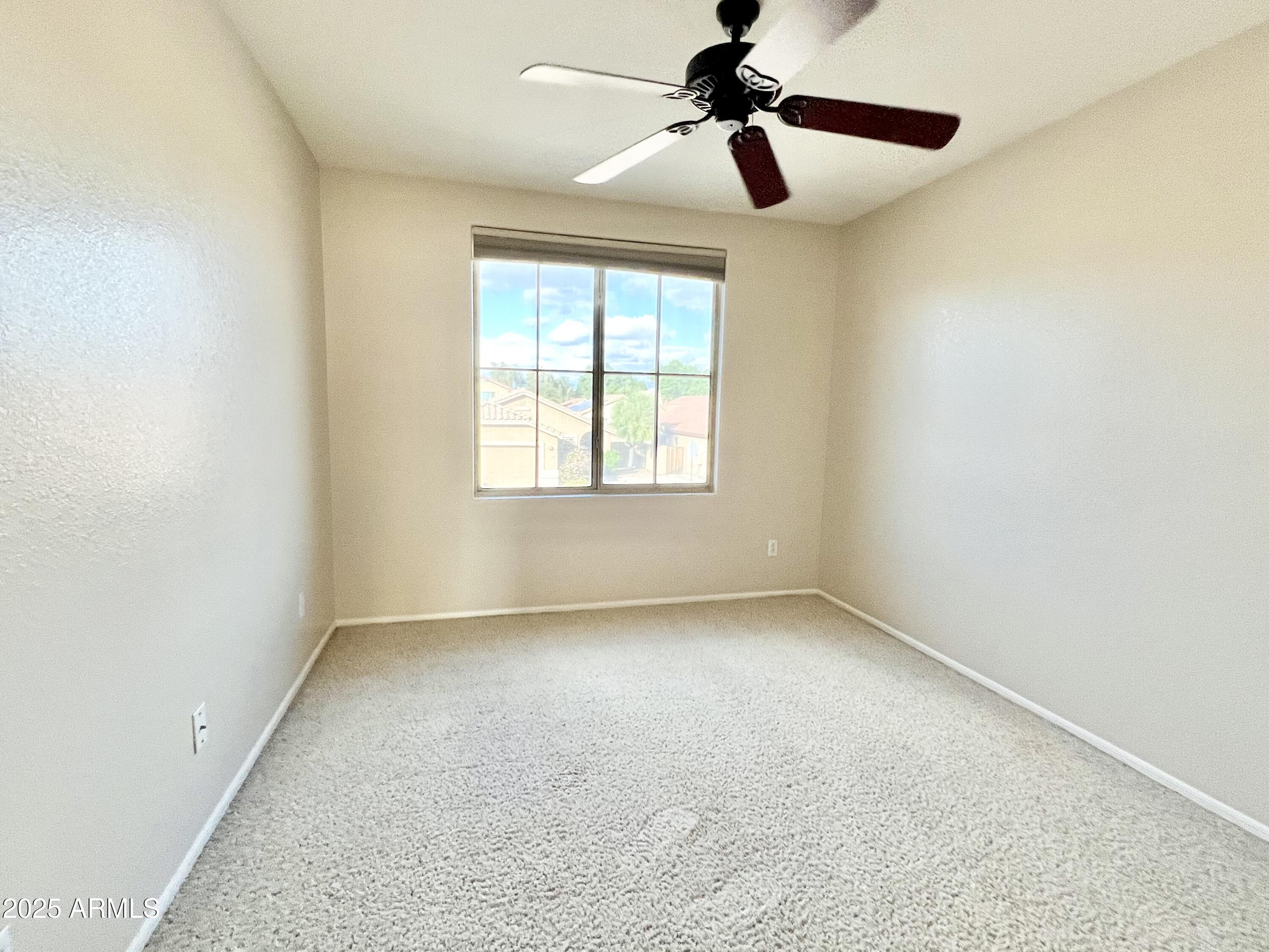 7309 West Mohawk Lane Glendale, AZ 85308 - Photo 22 of 24 a view of room with a ceiling fan and window