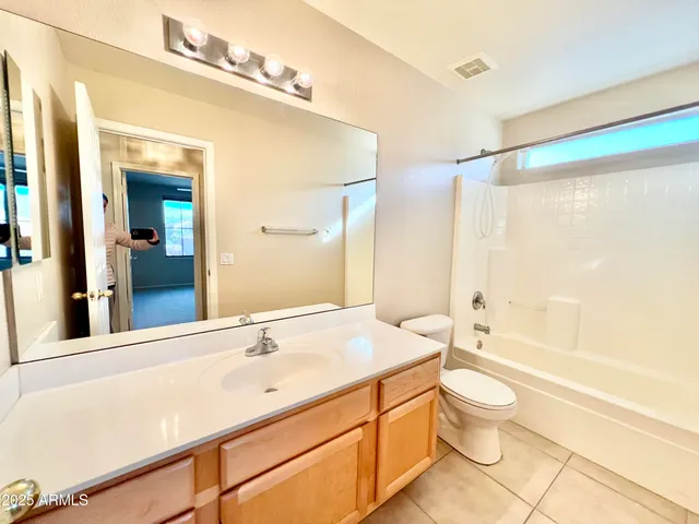 a bathroom with a double vanity sink toilet mirror and bathtub