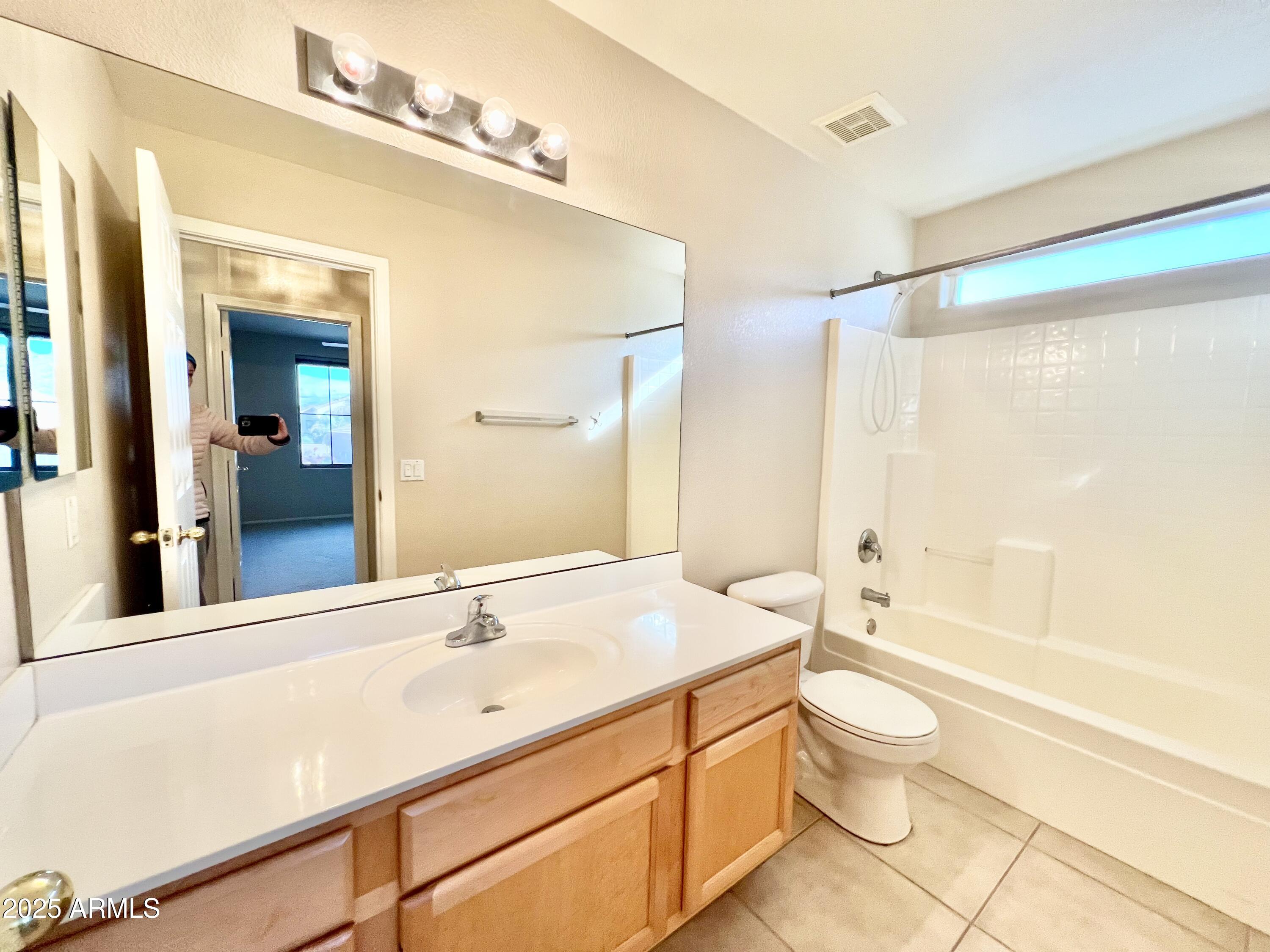 7309 West Mohawk Lane Glendale, AZ 85308 - Photo 24 of 24 a bathroom with a double vanity sink toilet mirror and bathtub