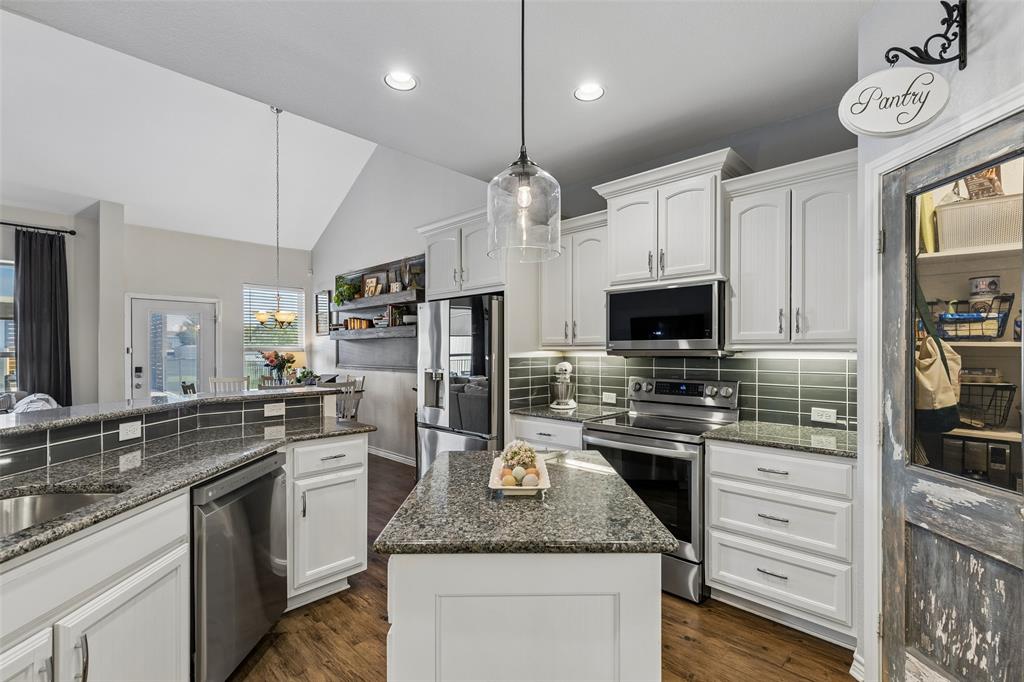 10176 Country View Lane Forney, TX 75126 - Photo 11 of 40 a kitchen with stainless steel appliances granite countertop a sink stove and refrigerator