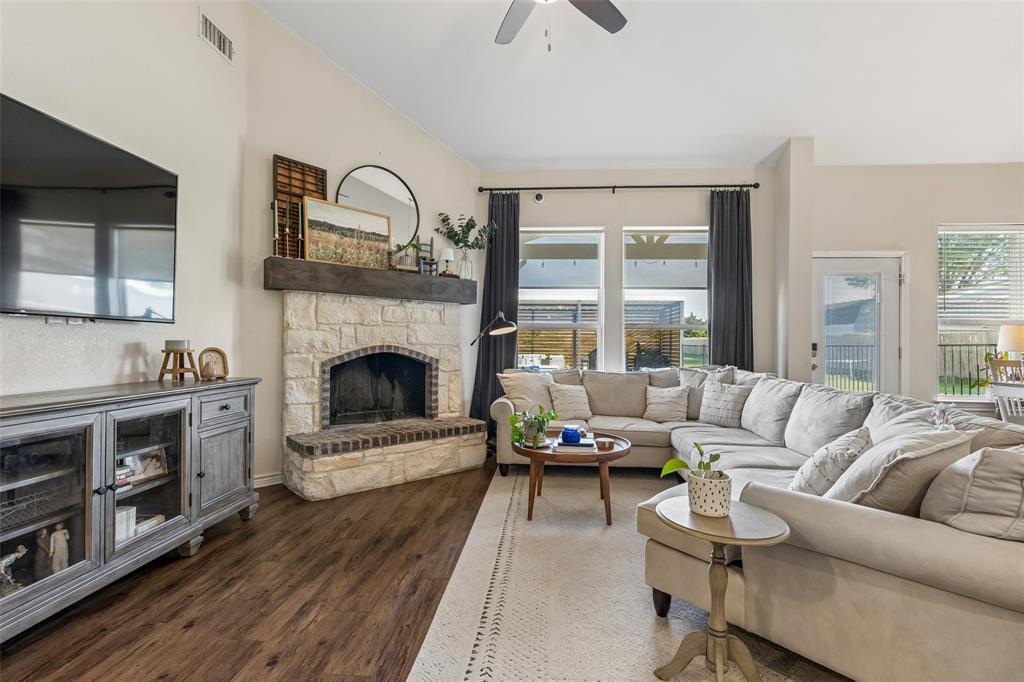 10176 Country View Lane Forney, TX 75126 - Photo 12 of 40 a living room with furniture and a fireplace