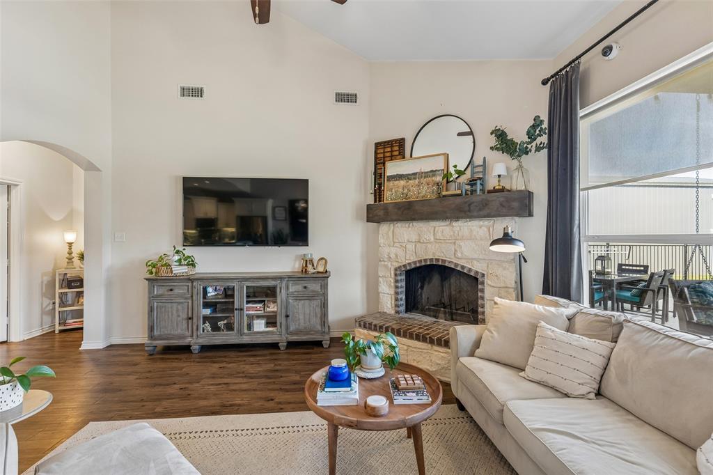10176 Country View Lane Forney, TX 75126 - Photo 18 of 40 a living room with furniture a flat screen tv and a fireplace