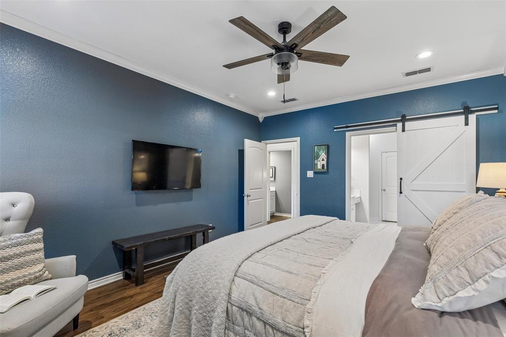 10176 Country View Lane Forney, TX 75126 - Photo 23 of 40 a bedroom with a bed window and a flat screen tv