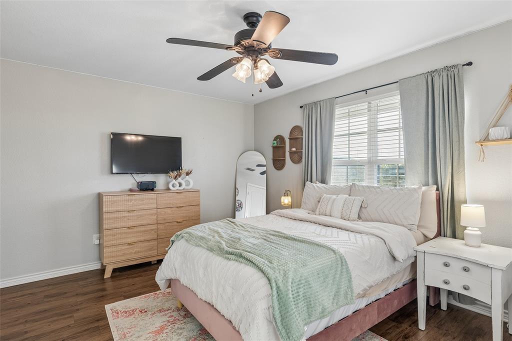 10176 Country View Lane Forney, TX 75126 - Photo 33 of 40 a bedroom with a bed and a flat screen tv