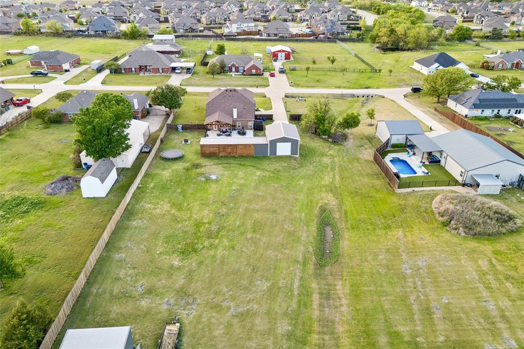 10176 Country View Lane Forney, TX 75126 - Photo 36 of 40 a view of a swimming pool with a lawn chairs and potted plants