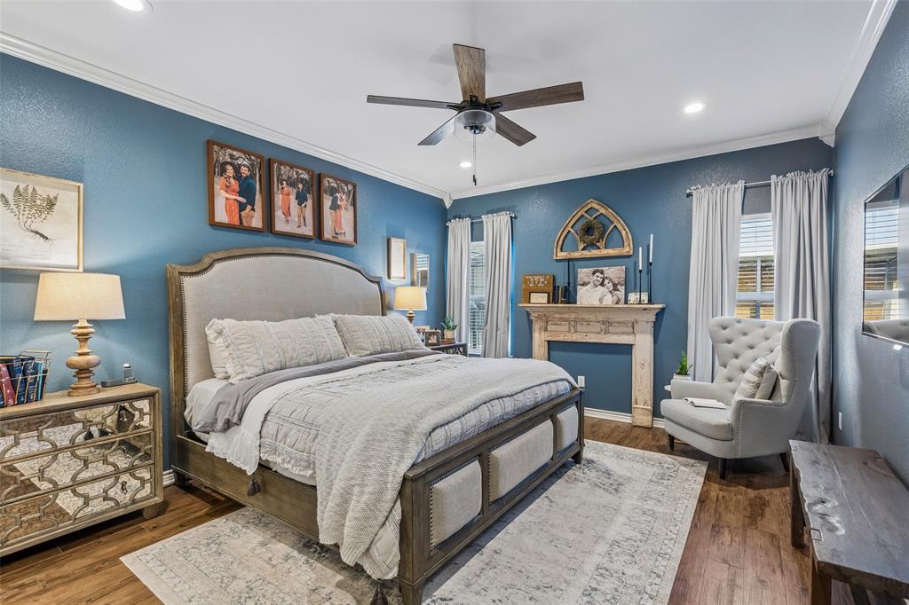 10176 Country View Lane Forney, TX 75126 - Photo 4 of 40 a bedroom with a large bed a chandelier and dresser