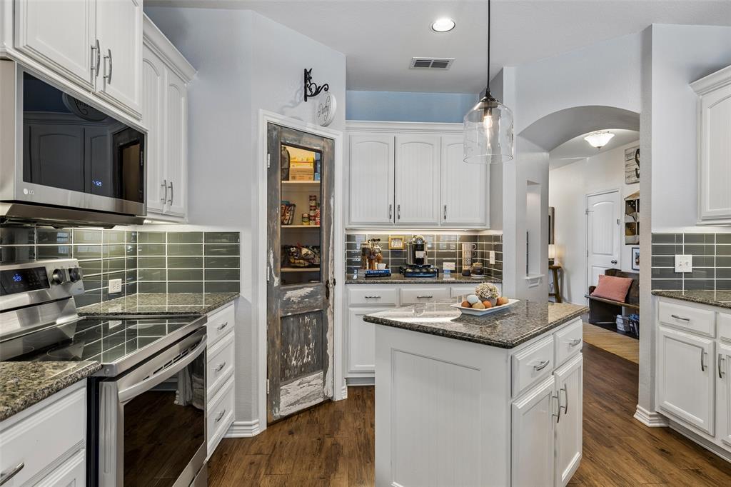 10176 Country View Lane Forney, TX 75126 - Photo 10 of 40 a kitchen with a stove and a microwave