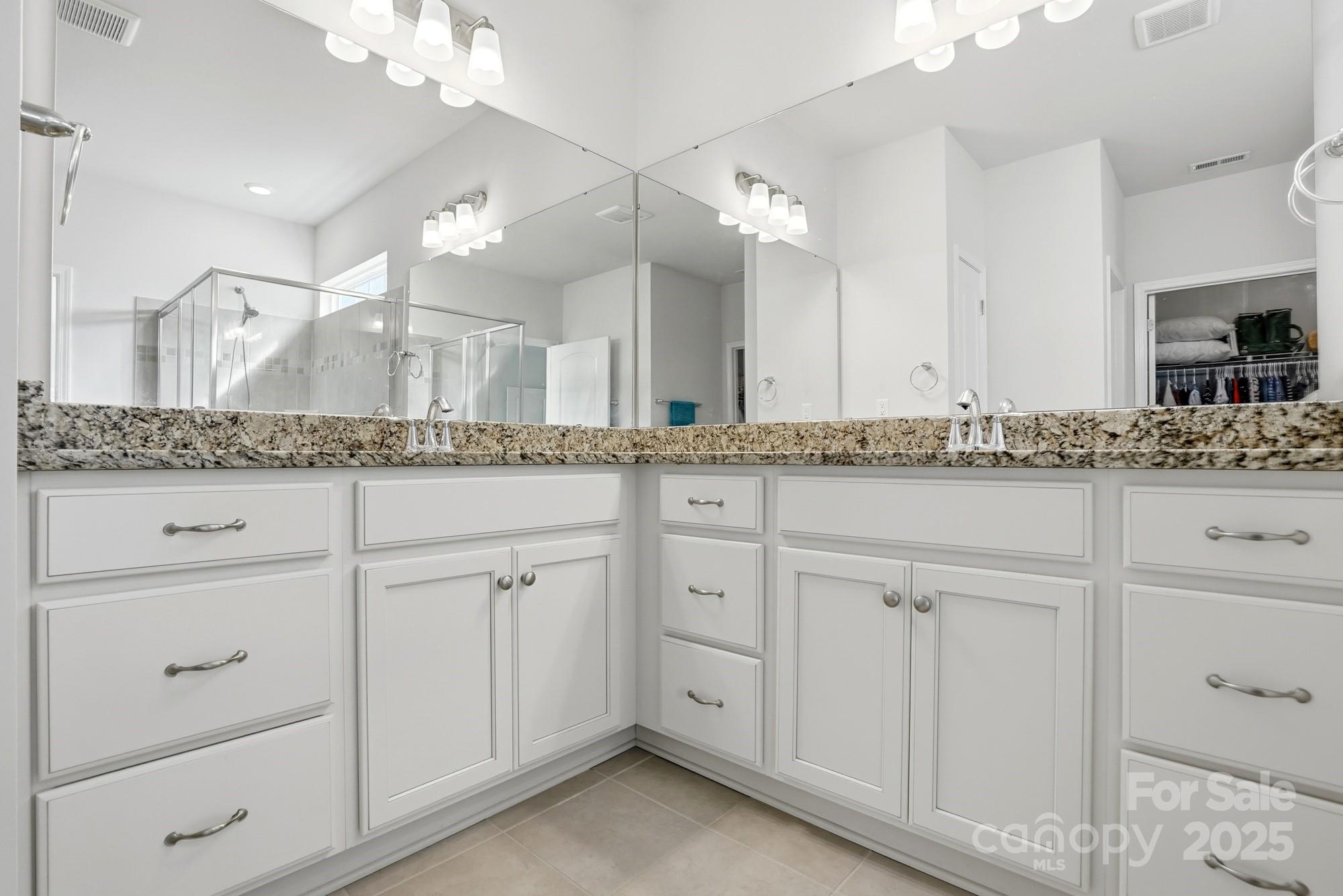 128 Van Gogh Trail Mount Holly, NC 28120 - Photo 27 of 48 a bathroom with a granite countertop sink and a mirror