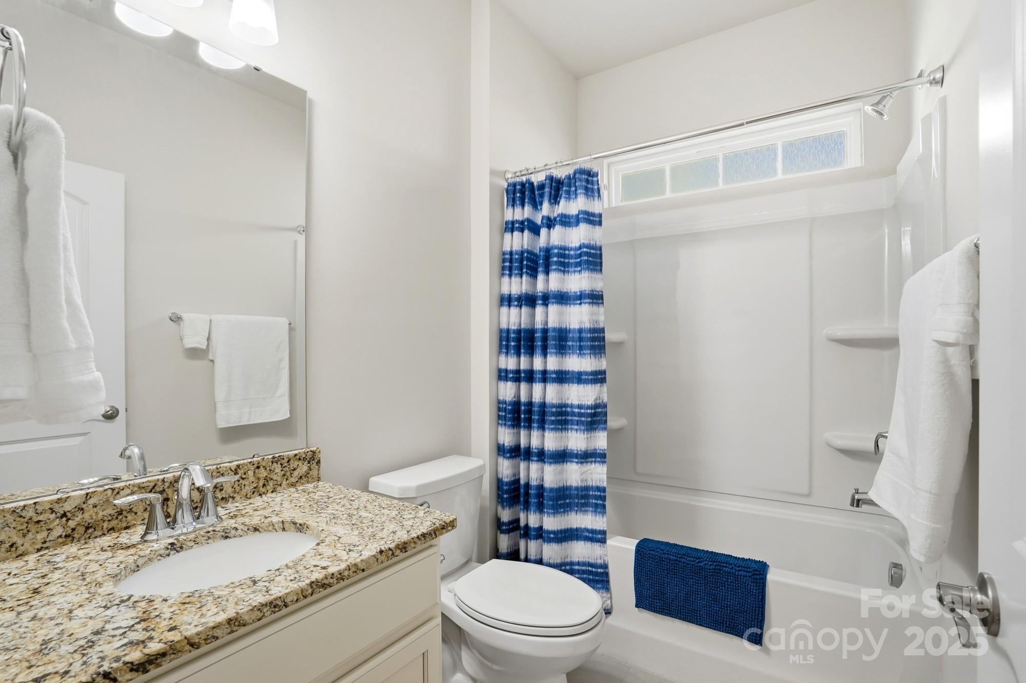 128 Van Gogh Trail Mount Holly, NC 28120 - Photo 9 of 48 a bathroom with a granite countertop toilet sink and shower