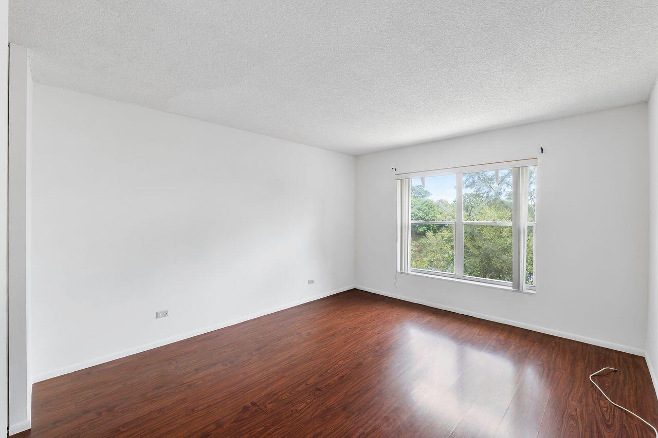 3720 Inverrary Drive, Unit 3D Lauderhill, FL 33319 - Photo 12 of 25 an empty room with wooden floor and windows