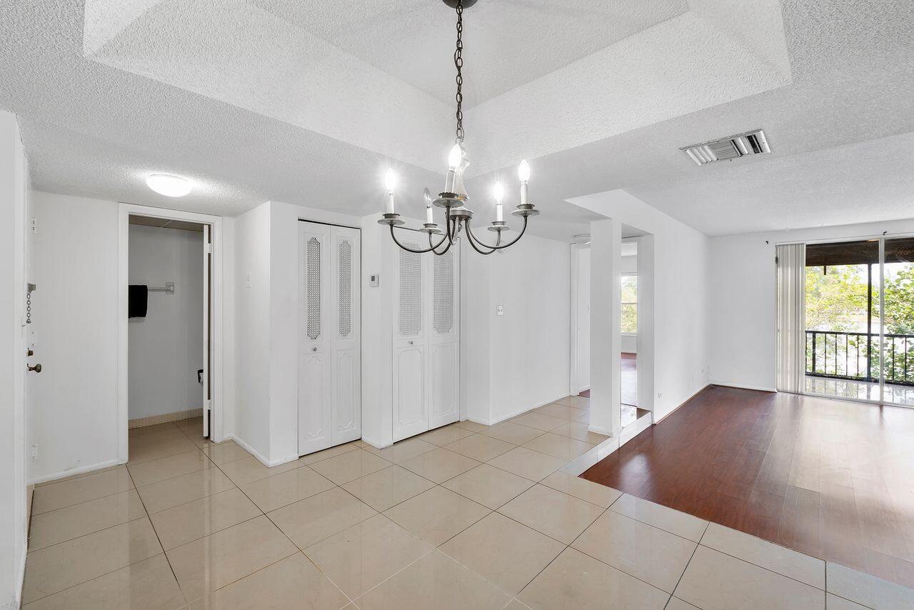 3720 Inverrary Drive, Unit 3D Lauderhill, FL 33319 - Photo 5 of 25 a view of a livingroom with a chandelier fan and windows