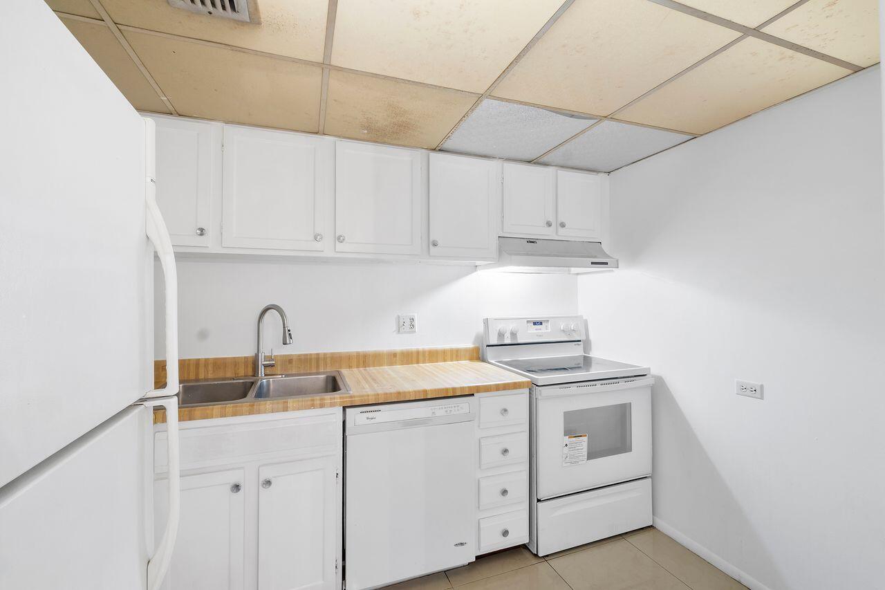 3720 Inverrary Drive, Unit 3D Lauderhill, FL 33319 - Photo 6 of 25 a kitchen with cabinets appliances a sink and a stove