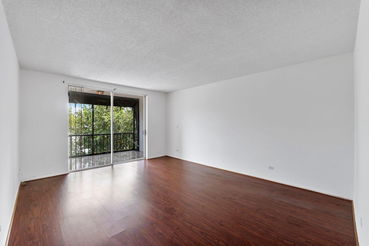 3720 Inverrary Drive, Unit 3D Lauderhill, FL 33319 - Photo 8 of 25 a view of an empty room with wooden floor and a window