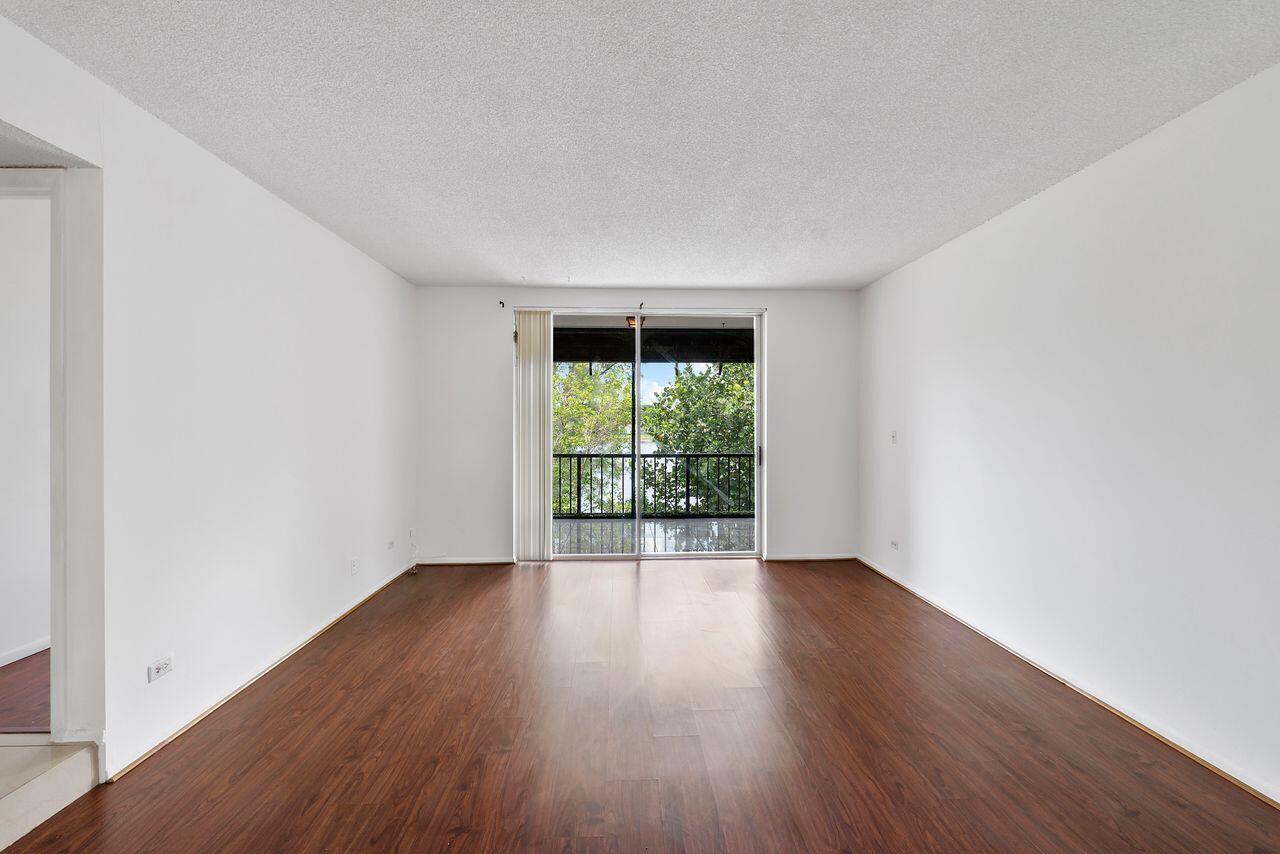 3720 Inverrary Drive, Unit 3D Lauderhill, FL 33319 - Photo 9 of 25 an empty room with wooden floor and windows