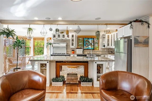 a kitchen with sink stove and cabinets