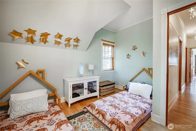 a view of a hallway with wooden floor and a dining room