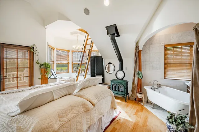 a bedroom with a large bed and a chandelier
