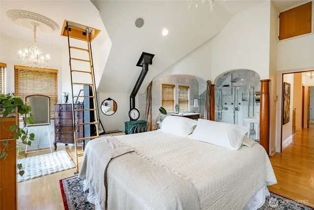 a bathroom with a sink a toilet a mirror and shower