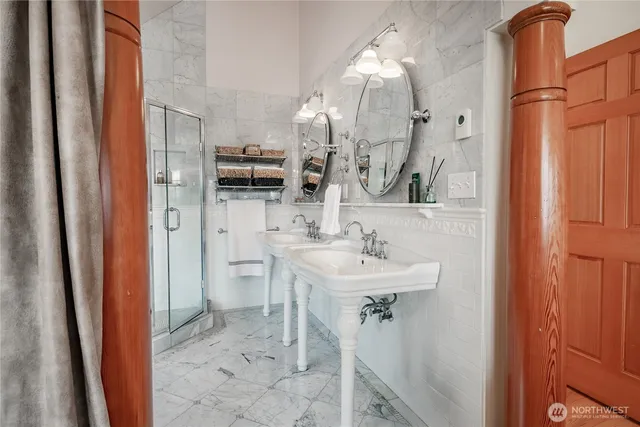 a bathroom with a tub sink and mirror
